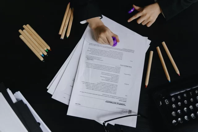 Hands reviewing a cost estimate document, reflecting professional approaches to Project Management in Netherlands.
