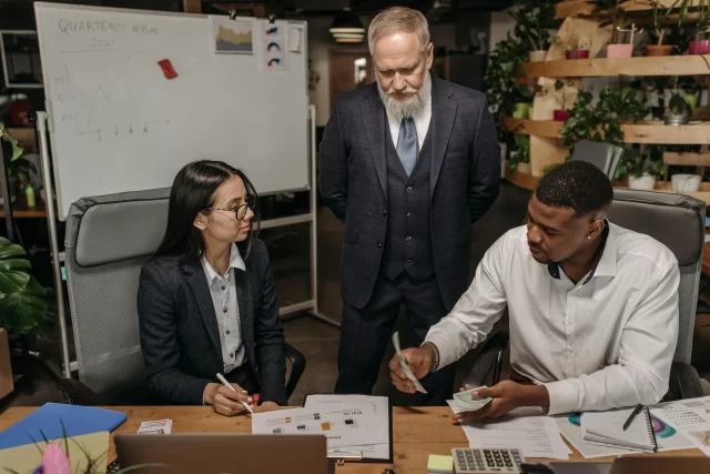 A diverse professional team reviewing financial documents during a session of Collaboration in Project Management.