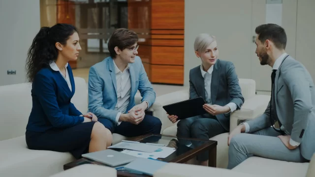 Professional team in a business meeting discussing Project Cost Management.