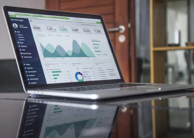 Laptop displaying a digital dashboard used to track metrics for change management in Basel.