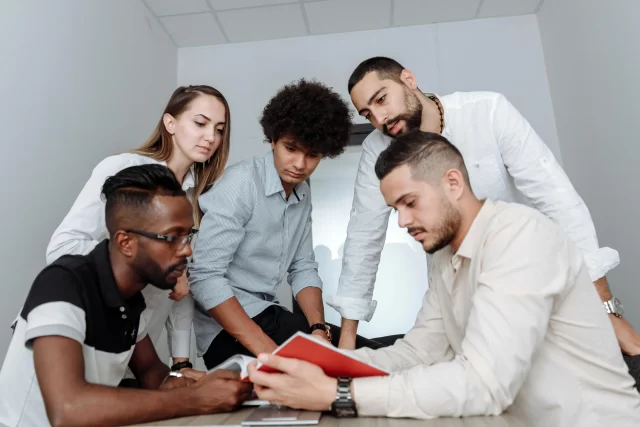 A diverse team collaborating on a strategy project during a professional consulting session.