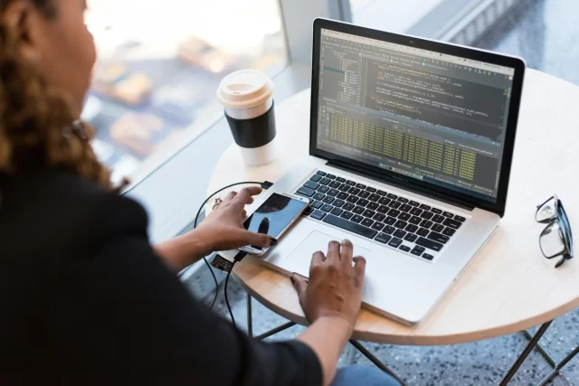 A software developer analyzing code on a laptop screen, illustrating Swiss Adaptive Software Development workflows.